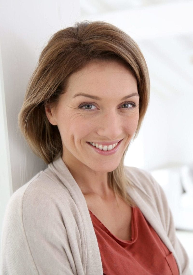 Middle-aged,Woman,Standing,In,Modern,Home
