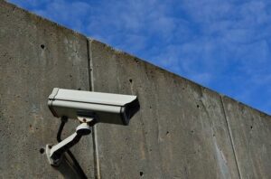 A security camera on a building, representing NYC apartment security features worth investing in