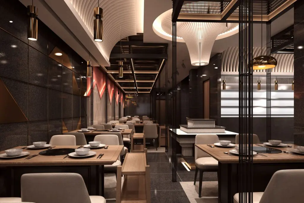 A modern, elegant restaurant interior with sleek dark walls, stylish lighting, and rows of wooden tables set with white dishes and beige cushioned chairs, creating a sophisticated dining atmosphere.