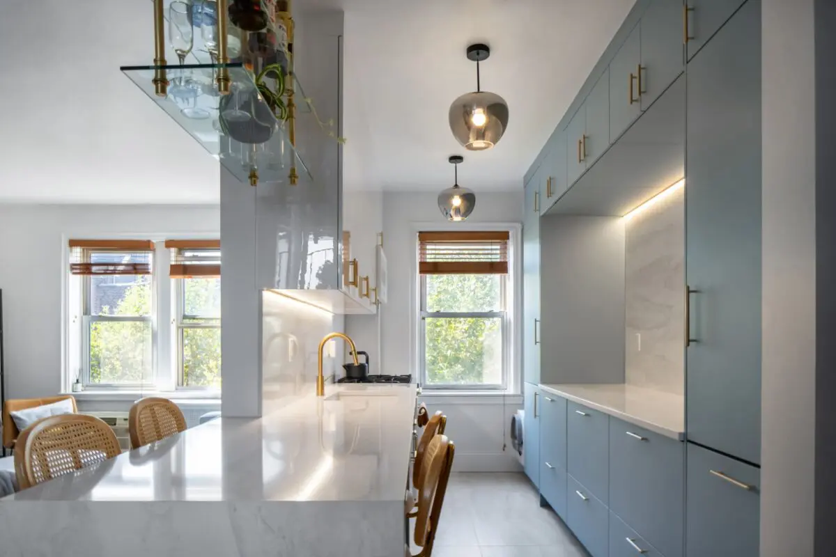 Luxury kitchen renovation in New York City apartment featuring sleek cabinets, stone countertops, and open layout design